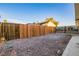 Gravel backyard with wooden fence and gated access at 414 Scenic Dr, Henderson, NV 89002