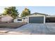 Updated single-story home with a gray garage door and rock landscaping at 414 Scenic Dr, Henderson, NV 89002