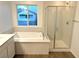 Bathroom features a soaking tub, walk-in shower, and window at 5076 Dule Grove St, Las Vegas, NV 89130