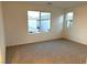 Bright bedroom with neutral carpet and two windows at 5076 Dule Grove St, Las Vegas, NV 89130