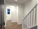 Bright entryway with wood-look tile floor and staircase at 5076 Dule Grove St, Las Vegas, NV 89130