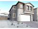 Two-story house with stone accents and a two-car garage at 5076 Dule Grove St, Las Vegas, NV 89130