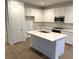 Modern kitchen with white cabinets and stainless steel appliances at 5076 Dule Grove St, Las Vegas, NV 89130