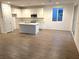 Modern kitchen with white cabinets, island, and stainless steel appliances at 5076 Dule Grove St, Las Vegas, NV 89130