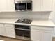 Stainless steel appliances and white shaker cabinets in kitchen at 5076 Dule Grove St, Las Vegas, NV 89130