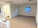 Open loft area with neutral carpet and a view of a bathroom at 5076 Dule Grove St, Las Vegas, NV 89130