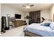 Spacious bedroom with large bed, TV, and ample storage at 7143 Nodding Thistle Ct, Las Vegas, NV 89178