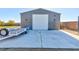 Detached garage with large roll-up door and ample parking at 7143 Nodding Thistle Ct, Las Vegas, NV 89178