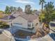 Single-story home with red tile roof and attached garage at 7209 Crooked Bow Cir, Las Vegas, NV 89149