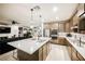 A kitchen featuring a large island with a stainless steel refrigerator and oven at 35 Flora Sagio Ave, Henderson, NV 89011