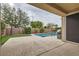 Relaxing backyard with a shimmering swimming pool, putting green, and mature trees at 3605 Sapphire Sea Ct, North Las Vegas, NV 89031