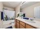 Bathroom with double sinks, a large mirror, and a shower-tub combination at 3605 Sapphire Sea Ct, North Las Vegas, NV 89031