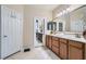 This bathroom features a dual sink vanity, ample storage space, and a framed mirror at 3605 Sapphire Sea Ct, North Las Vegas, NV 89031