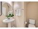 Charming powder room with a pedestal sink and neutral decor at 3605 Sapphire Sea Ct, North Las Vegas, NV 89031