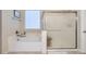 This bathroom includes a bathtub, a separate shower with glass doors, and a tiled floor at 3605 Sapphire Sea Ct, North Las Vegas, NV 89031