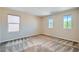 Empty bedroom with carpet flooring and natural light streaming through the windows at 3605 Sapphire Sea Ct, North Las Vegas, NV 89031