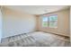This is a spacious bedroom with neutral walls, plush carpet, and two bright windows at 3605 Sapphire Sea Ct, North Las Vegas, NV 89031