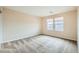 This is a spacious bedroom with neutral walls, plush carpet, and two large windows at 3605 Sapphire Sea Ct, North Las Vegas, NV 89031