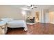 This bedroom features hardwood floors, a ceiling fan, a desk area, and an ensuite bathroom for added convenience at 3605 Sapphire Sea Ct, North Las Vegas, NV 89031