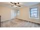 Empty bedroom with carpet flooring, ceiling fan, natural light streaming through the windows, and a white door at 3605 Sapphire Sea Ct, North Las Vegas, NV 89031