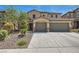 Two-story home features a three-car garage, desert landscaping, and a stucco exterior at 3605 Sapphire Sea Ct, North Las Vegas, NV 89031