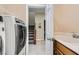 The laundry room features a sink, tile flooring, and a washing machine and dryer at 3605 Sapphire Sea Ct, North Las Vegas, NV 89031