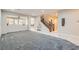 Spacious living room boasts neutral paint, carpet, and an open floor plan that flows into the dining area at 3605 Sapphire Sea Ct, North Las Vegas, NV 89031