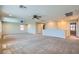 Spacious loft with neutral carpeting and multiple ceiling fans with lights at 3605 Sapphire Sea Ct, North Las Vegas, NV 89031
