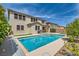 Backyard pool with lush trees, a jacuzzi, and a two story home in the background at 3605 Sapphire Sea Ct, North Las Vegas, NV 89031
