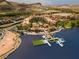 Aerial view of lakefront residences with boat docks and a charming European-style village at 44 Alta Cascata Pl, Henderson, NV 89011