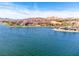Beautiful aerial view of a lake surrounded by golf course, luxurious homes and mountains at 44 Alta Cascata Pl, Henderson, NV 89011
