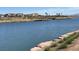 Stunning lake view with palm trees, a bridge, and waterfront properties in the distance at 44 Alta Cascata Pl, Henderson, NV 89011