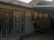 Exterior view of the backyard showing an access door and window with metal security bars that requires cleaning at 1552 Dorothy Ave, Las Vegas, NV 89119