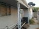 Exterior facade of the house needs upkeep, featuring a covered patio and satellite dishes on the roof at 1552 Dorothy Ave, Las Vegas, NV 89119