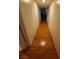 Narrow hallway with hardwood floors, featuring neutral walls and standard lighting needs decluttering at 1552 Dorothy Ave, Las Vegas, NV 89119