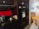 A partial view of a kitchen with black appliances, dark cabinetry and red backsplash at 1552 Dorothy Ave, Las Vegas, NV 89119