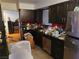 A view of a kitchen with black appliances, dark cabinets, red backsplash and tile floors at 1552 Dorothy Ave, Las Vegas, NV 89119