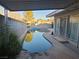 Backyard view of a pool with a covered patio and privacy fence at 1552 Dorothy Ave, Las Vegas, NV 89119