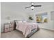 Charming bedroom with a queen bed and window seat at 2628 Starfish Ct, Las Vegas, NV 89128