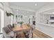 Open dining area with a rustic wooden table and modern chairs at 2628 Starfish Ct, Las Vegas, NV 89128