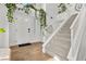 Bright entryway with white walls, wood floors, and a modern staircase at 2628 Starfish Ct, Las Vegas, NV 89128
