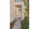 Beige stucco home with a light-beige front door and walkway at 2628 Starfish Ct, Las Vegas, NV 89128