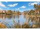 Serene lake view with bridge and tall grasses in foreground at 2628 Starfish Ct, Las Vegas, NV 89128