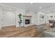 Bright living room with fireplace, hardwood floors, and a stylish glass coffee table at 2628 Starfish Ct, Las Vegas, NV 89128