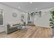 Spacious living area with hardwood floors, large windows, and a comfortable sofa at 2628 Starfish Ct, Las Vegas, NV 89128
