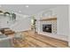 Two-story living room featuring hardwood floors, a fireplace, and an open floor plan at 2628 Starfish Ct, Las Vegas, NV 89128