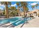 Inviting community pool with palm trees and patio furniture at 2628 Starfish Ct, Las Vegas, NV 89128