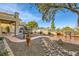 Landscaped backyard with a winding path, stone features, and a patio seating area at 373 Via Sonador, Henderson, NV 89012