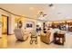 Open living room with kitchen access, seating area, and large windows at 373 Via Sonador, Henderson, NV 89012