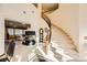 Grand curved staircase with wooden railings leading to the upper level at 373 Via Sonador, Henderson, NV 89012
